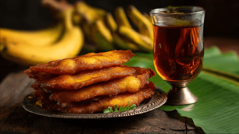 Crispy Kerala Pazham Pori (Banana Fry) served with black tea – South Indian snack photo