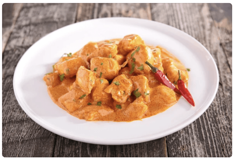 instantrecipies - Authentic Indian Butter Chicken (Murgh Makhani) served with basmati rice and naan on a white plate – a quick and easy instant recipe for rich, creamy curry at home