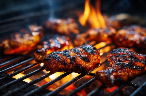 Grilling chicken on charcoal for smoky flavor and juicy texture